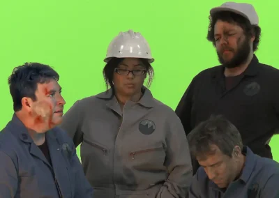 4 actors on a green screen set, with makeup to look injured and dirty.